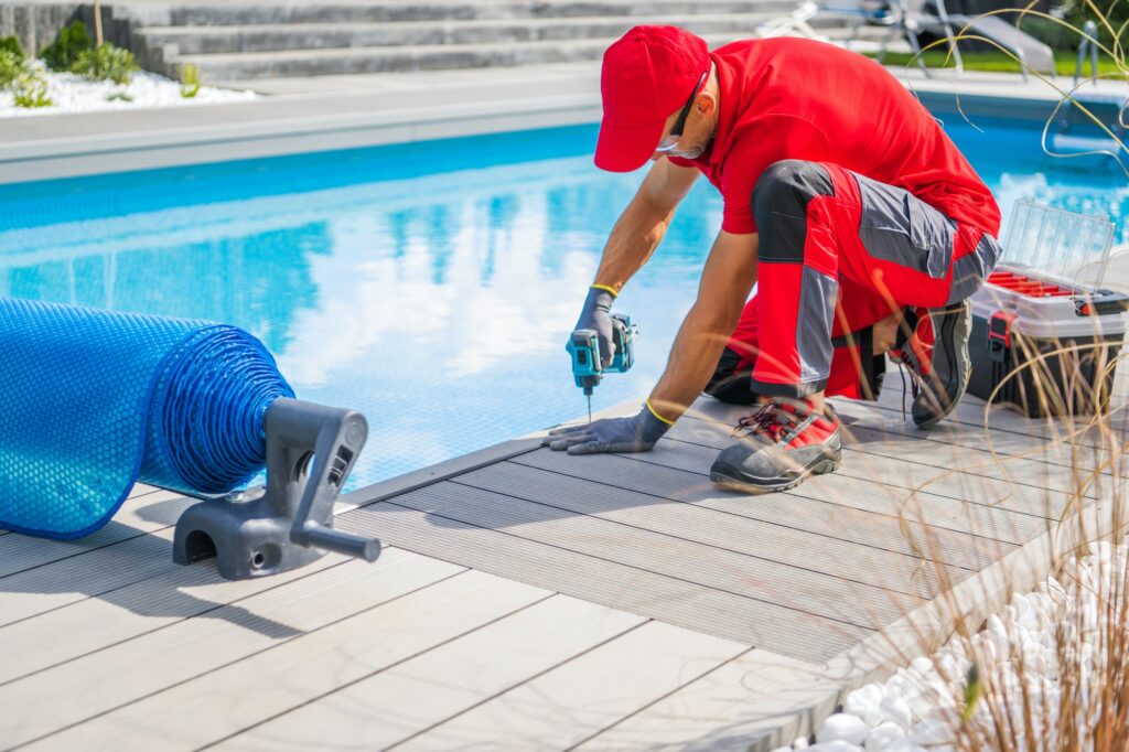 Professional Outdoor Swimming Pools Worker Finishing Composite Deck Installation
